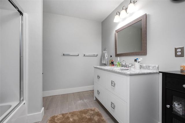 bathroom featuring vanity and enclosed tub / shower combo