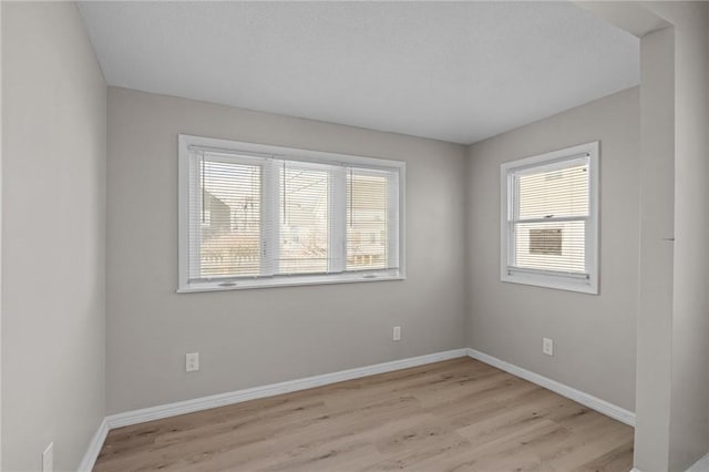 empty room with light hardwood / wood-style flooring