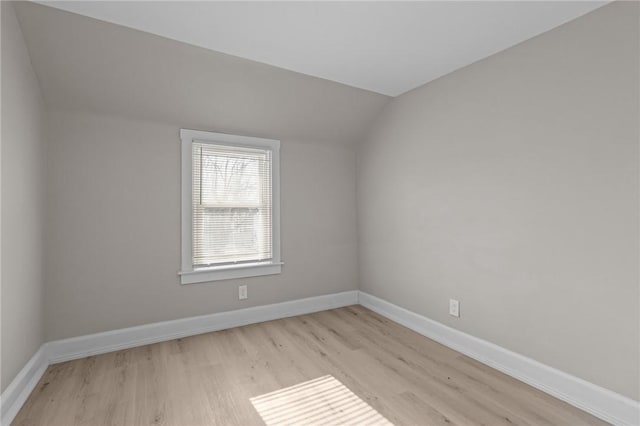 bonus room with lofted ceiling and light hardwood / wood-style floors