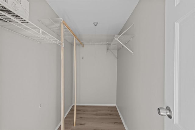 walk in closet featuring hardwood / wood-style floors