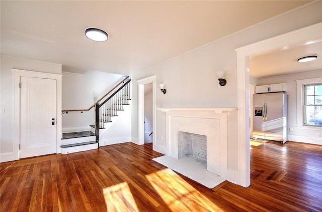 unfurnished living room featuring hardwood / wood-style flooring