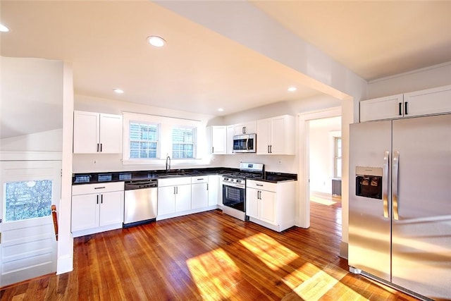 kitchen featuring sink, stainless steel appliances, dark hardwood / wood-style floors, and white cabinets