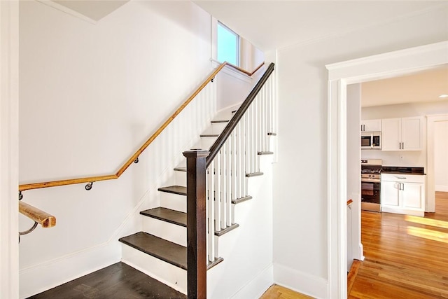 stairs with hardwood / wood-style floors