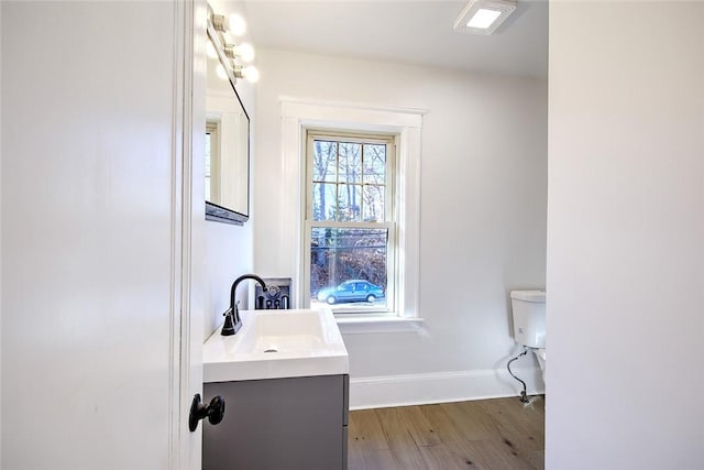 bathroom featuring hardwood / wood-style flooring, vanity, and toilet