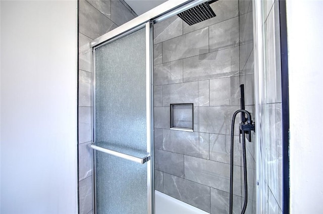 interior details featuring an enclosed shower