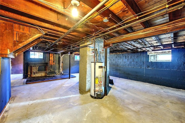 basement featuring gas water heater and plenty of natural light