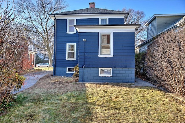 rear view of property with a lawn