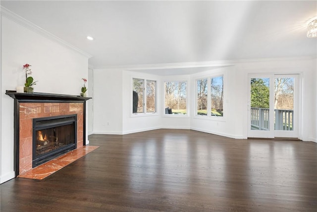 unfurnished living room featuring dark wood-type flooring, ornamental molding, and a tiled fireplace