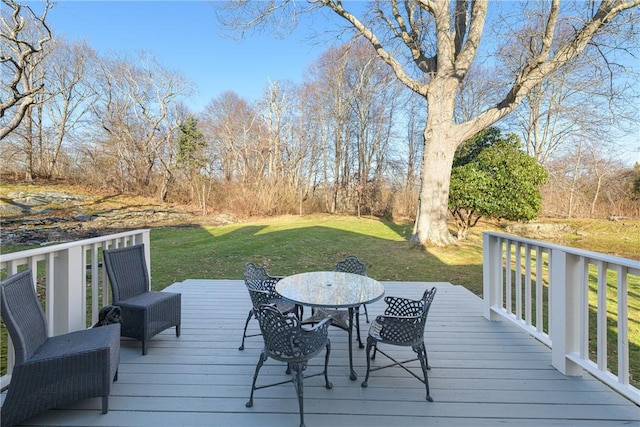 wooden terrace featuring a yard