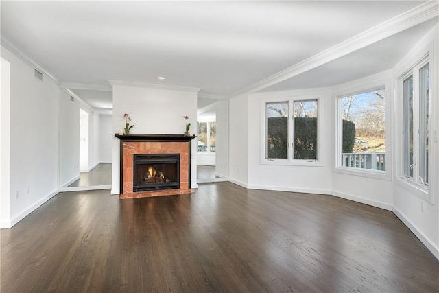 unfurnished living room featuring ornamental molding, dark hardwood / wood-style floors, and a fireplace