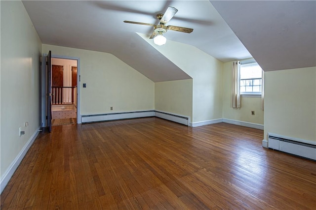 additional living space with hardwood / wood-style flooring, a baseboard radiator, lofted ceiling, and ceiling fan