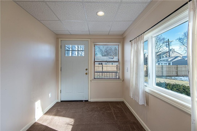 doorway featuring a paneled ceiling and dark carpet