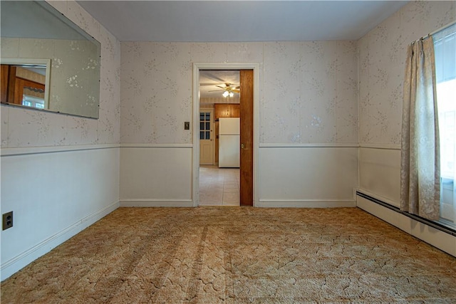 carpeted spare room with baseboard heating