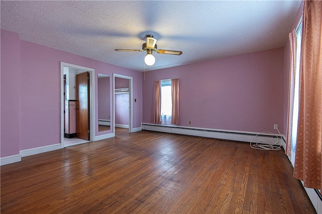 unfurnished bedroom with ceiling fan, dark hardwood / wood-style flooring, a textured ceiling, and a baseboard heating unit