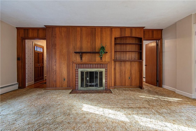 unfurnished living room featuring built in shelves, wood walls, a baseboard radiator, carpet floors, and a fireplace