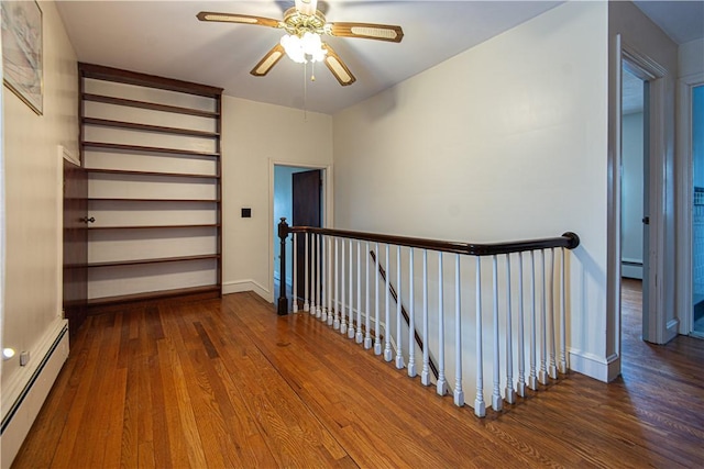 hall featuring baseboard heating and dark hardwood / wood-style floors