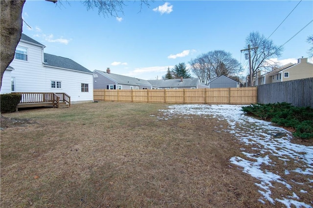 yard covered in snow featuring a deck