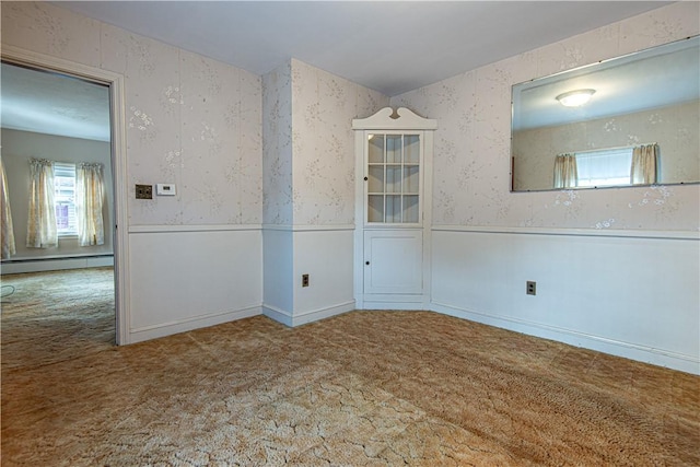 spare room with carpet floors and baseboard heating