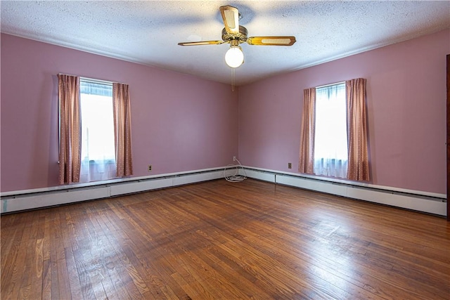 unfurnished room with hardwood / wood-style flooring, a wealth of natural light, a textured ceiling, and ceiling fan