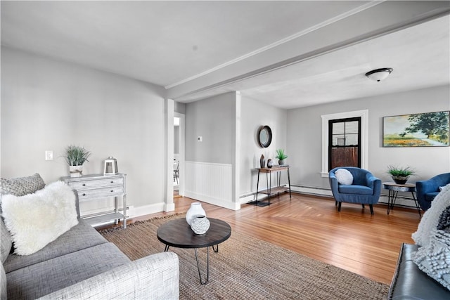 living room with a baseboard heating unit and hardwood / wood-style flooring