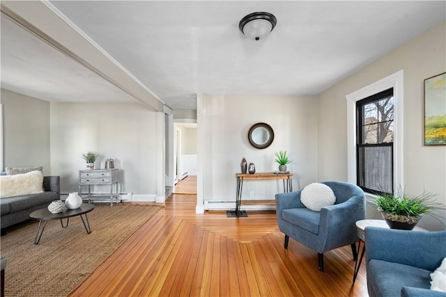 living area featuring light hardwood / wood-style flooring and a baseboard heating unit