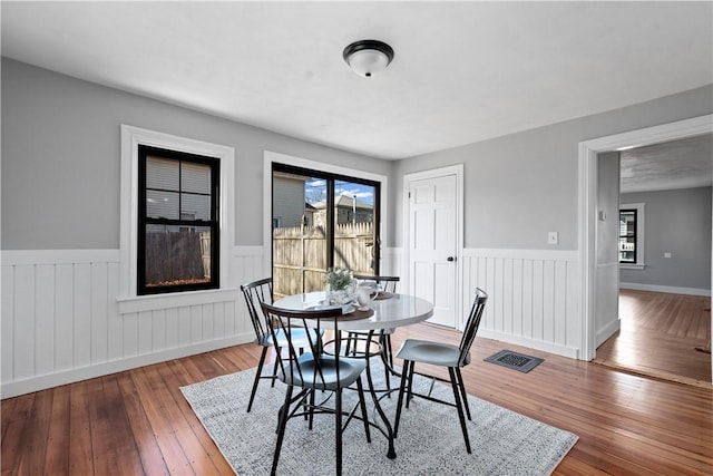 dining room featuring hardwood / wood-style flooring and a wealth of natural light