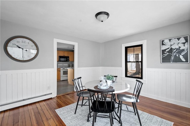 dining area featuring dark hardwood / wood-style flooring and baseboard heating