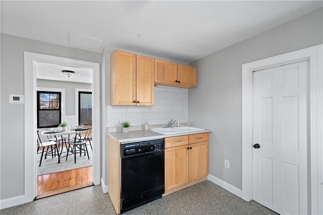 kitchen featuring dishwasher, sink, and light brown cabinetry