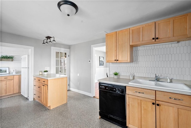 kitchen featuring light brown cabinetry, sink, and white appliances