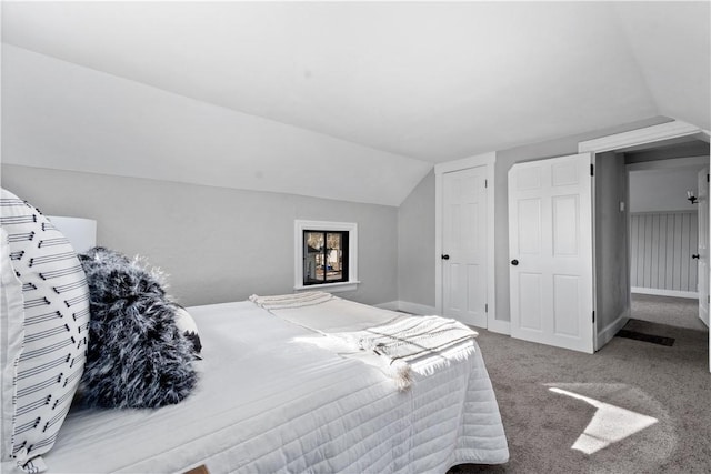 bedroom with vaulted ceiling and carpet flooring