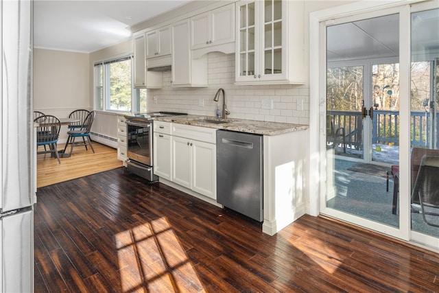 kitchen featuring sink, appliances with stainless steel finishes, light stone counters, tasteful backsplash, and white cabinets