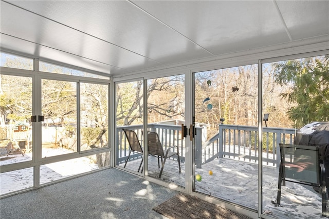 unfurnished sunroom with lofted ceiling