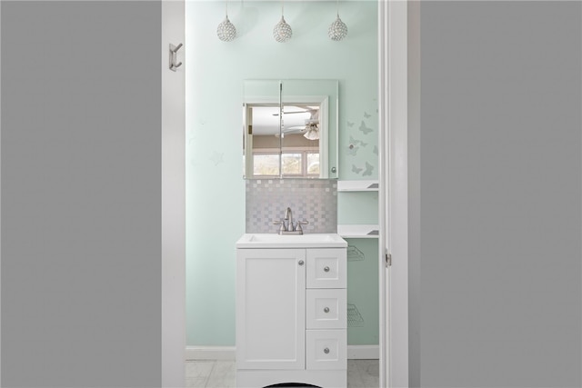 bathroom with tasteful backsplash and vanity