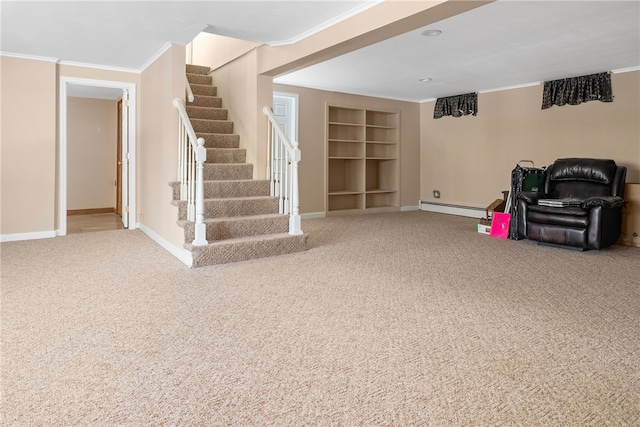 basement with a baseboard heating unit, crown molding, carpet floors, and built in features