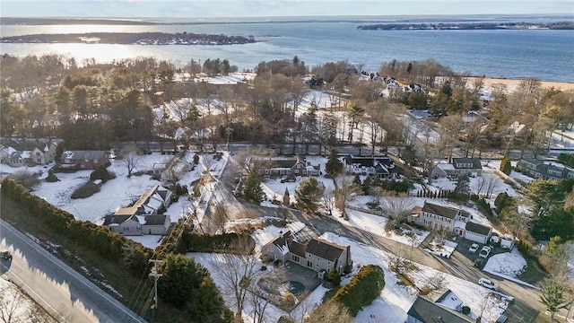 snowy aerial view with a water view