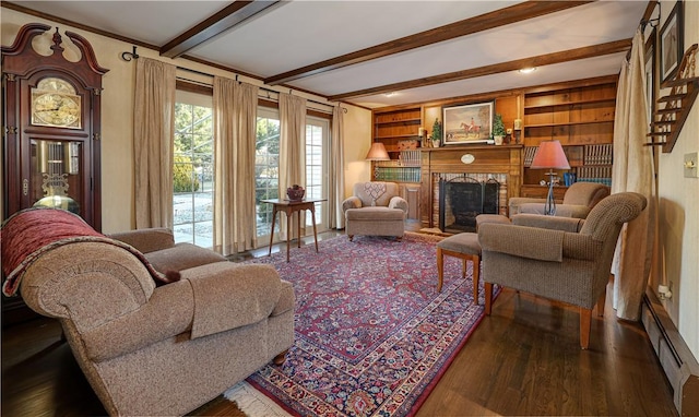 living room featuring beam ceiling, dark hardwood / wood-style floors, built in shelves, and baseboard heating