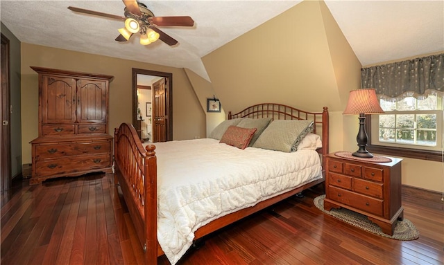 bedroom with ceiling fan, lofted ceiling, and dark hardwood / wood-style flooring