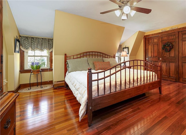 bedroom with hardwood / wood-style floors and a baseboard heating unit