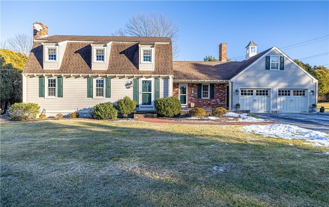 cape cod-style house featuring a garage and a front yard