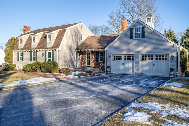 new england style home featuring a garage