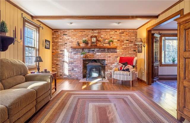 living room with hardwood / wood-style floors, beam ceiling, ornamental molding, and baseboard heating