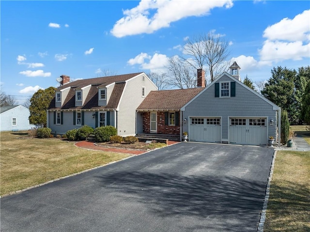 view of front of house featuring aphalt driveway, a gambrel roof, a chimney, and a front lawn