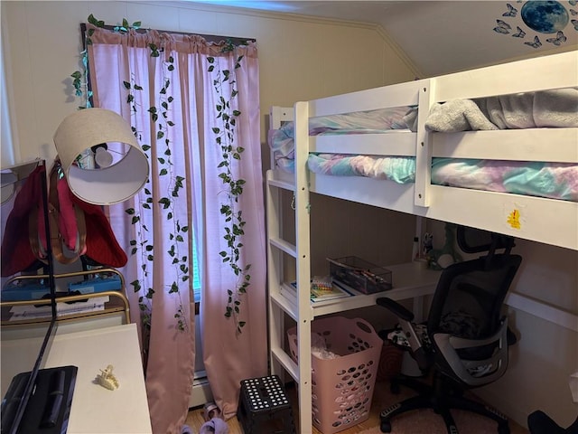 bedroom featuring vaulted ceiling and a baseboard heating unit