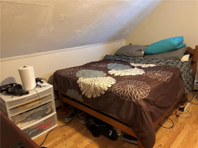 bedroom featuring wood-type flooring and lofted ceiling