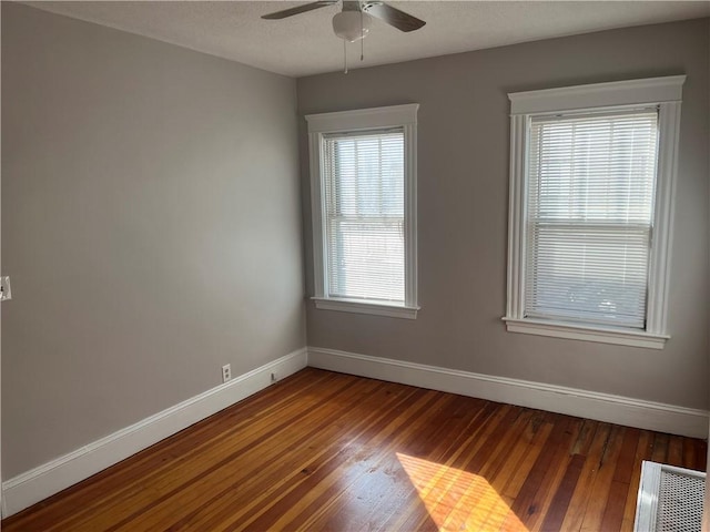 spare room featuring ceiling fan and hardwood / wood-style floors