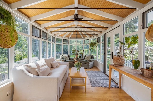 sunroom / solarium with vaulted ceiling with beams, wood ceiling, and ceiling fan