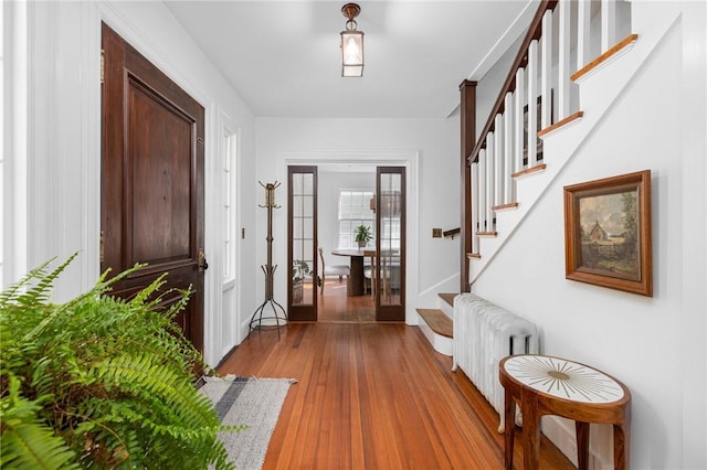 foyer featuring hardwood / wood-style flooring and radiator