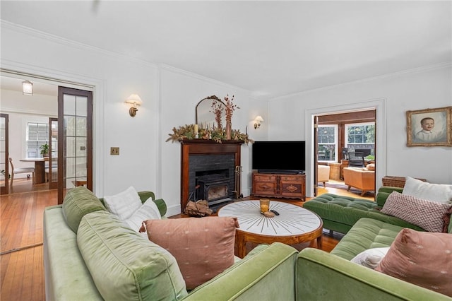 living room featuring ornamental molding and wood-type flooring