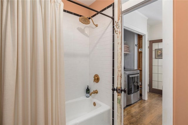 bathroom with shower / tub combo with curtain, washer / dryer, and wood-type flooring