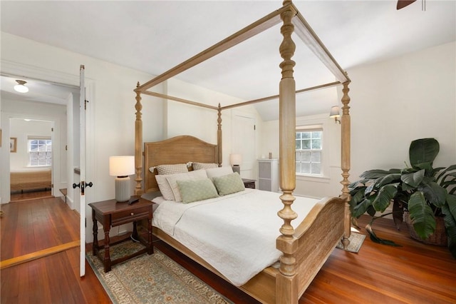 bedroom featuring hardwood / wood-style flooring and multiple windows